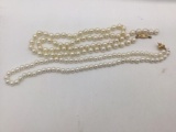 Two pearl necklaces with 14k gold clasps. Longest measures approx 25 inches.
