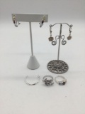 Collection of sterling silver jewelry, some with cut stones. Rings and earrings.