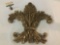 Wooden gold tone fleur-de-lis wall art piece, approx. 19x20x3 inches.