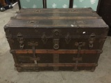 Antique steamer trunk with leather handles, one handle is split, approx 36x22x24 inches