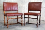 2 matching antique spiral carved wood chairs with brown leather upholstery and studded seams