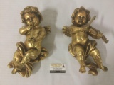 Hanging gold painted set of cherubs playing instruments, approx. 14x8x7.5 inches.