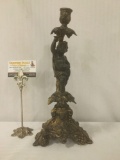 Antique gold tone metal candle holder w/grapevine & cherub decorations, approx. 7x7x14 inches.