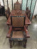 Mid-century Spanish carved dining table with ornate pressed leather chairs. approx 79x39x31 in.