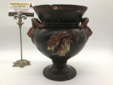 Late 1800s antique black French vase w/ram heads & faded angel designs. Approx. 9x8x8 inches