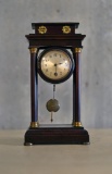 Vintage mantle clock w/wooden pillars, pendulum & key, untested, approx. 6x4x12 inches.