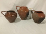 Three vintage/antique clay one-handled vases, approx. 9x10x10.5 inches.