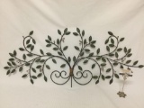 Decorative floral design metal wall hanging art piece, approx 45 x 20 inches.