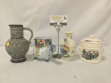 Collection of four stoneware pieces. Karafe, jar, and more. Largest measures approx 7x4.5x5 inches.