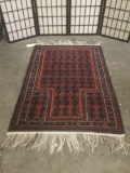Small handwoven wool rug w/ fringe & colorful geometric patterns & fringe. Approx. 63x35 inches.