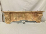 A red antique wood coat rack. Measures approx 43x17x9 inches.