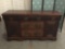 Antique Victorian era English side board with hand carved accents. Measures approx 60x35x19 inches.