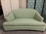 Green upholstered loveseat couch, approx 66 x 34 x 33 inches, upholstery shows wear, see pics.