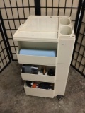 Rolling plastic art station storage cart filled with art supplies. Measures approx 29x17x16 inches.