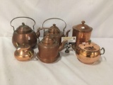 Collection of 6 copper tea ports and dishes. Largest measures approx 8x8x6 inches.