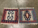 Pair of hand woven rugs / mats in red and blue tones w/ geometric design, approx 26 x 25 inches