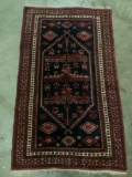 Handwoven wool rug in red tones with geometric design, signed Halt, Approx 40 x 66 inches