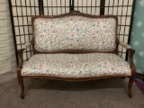 Antique loveseat or settee w/ floral upholstery & carved floral detailing. Some wear, see pics