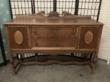 Art deco mahogany two-drawer sideboard/buffet table w/carved backsplash approx. 60x21x44 inches.