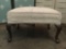 Vintage ottoman w/ white upholstery & seashell designs on legs. Shows ear, see pics.