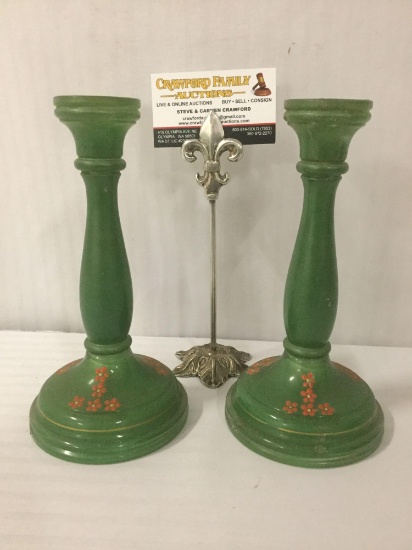 Thick green glass candle sticks w/painted flowers, approx. 5x5x8 inches each.