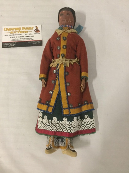 Doll made out of organic material w/colorful traditional outfit, approx. 5x11x2 inches.
