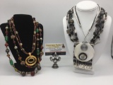 4 pieces of colorful estate jewelry, incl. shell, bead, & metal necklaces.