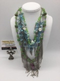 4 pieces of estate jewelry, incl. metal, bead, & plastic necklaces, approx. 30x1x0.5 inches.