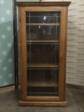 Wood curio/entertainment cabinet w/ 4 shelves & casters, approx. 26x18x51 inches.