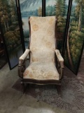Vintage rocking chair with floral upholstered pattern.