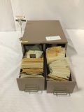 Large collection of loose postage stamps from Central and South America in metal file cabinet.