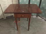 Antique drop leaf side table. Measures approx 29x24x18 inches with the leaves down.
