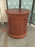 Modern solid wood cylindrical end table with cabinet. approx 26x24x24 in