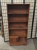 Wooden book shelf with bottom cabinet.