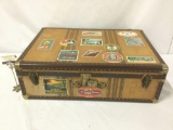 Vintage wooden suitcase covered in vintage hotel stickers, approx. 30x10x20.5 inches.