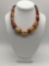 Vintage African metal, wood bead and leather necklace. Approx 18.5x1x1 inches.