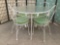 Metal glass top patio table & 4 green upholstered chairs w/metal leaf design, approx 42x42x29 in.