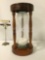 Vintage wood, glass, & white sand hourglass, approx. 6x6x12.5 inches.