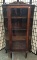 Late 1800s oak curved glass china cabinet. Approx 64x36x14 inches.