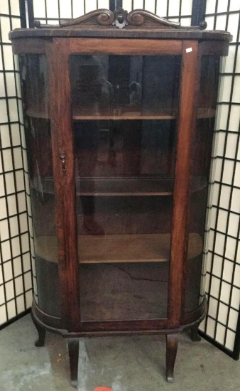 Late 1800s oak curved glass china cabinet. Approx 64x36x14 inches.
