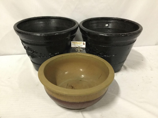 3 stoneware planters, 1 glazed, and 2 with leaf design. Largest approx 12x16 inches.