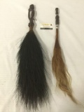 Pair of indigenous hair/feather fly swatters w/carved wood handles decorated w/faces 29x7x4 in.