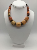 Vintage African metal, wood bead and leather necklace. Approx 18.5x1x1 inches.