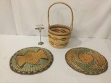 3 colorful woven wicker folk art pieces, incl. 2 plates and basket, largest approx. 10x10x18 inches.