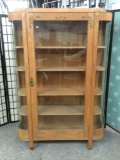 Large antique wooden curio cabinet w/4 shelves, elegant pulls & floral design. Approx. 48x14x72 in.