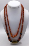 2 vintage foreign necklaces, 1 w/ African glass trade beads and 1 w/ glass/stone beads approx 26 in.