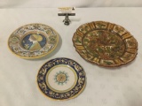 Three Italian painted plates depicting birds, flowers, a woman, and dragons, from Deruta, Italy.