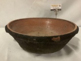 Large antique dark two-handled earthenware bowl, approx. 18x15x5 inches.