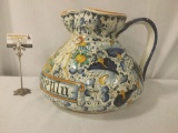 Large hand painted Italian pitcher w/cherub & floral designs. Signed by artist Montelupo Fiorentine