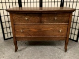 Vintage/antique early 1900s tiger oak three-drawer dresser w/casters, approx. 36x20x27 inches.